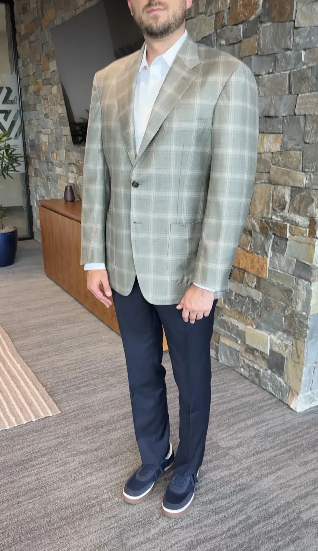 Client wearing a green plaid custom sport coat with navy trousers