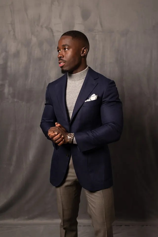 Navy custom sport coat worn over a grey turtleneck